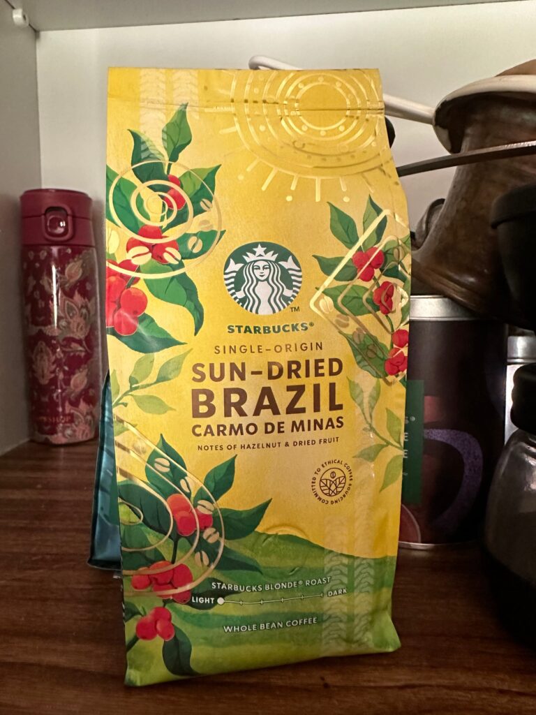 A Starbucks blonde-roasted single-origin whole-bean coffee package written "sun-dried Brazil Carmos de Minas"